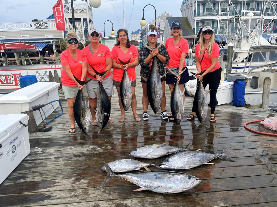 Ladies holding fish on pier